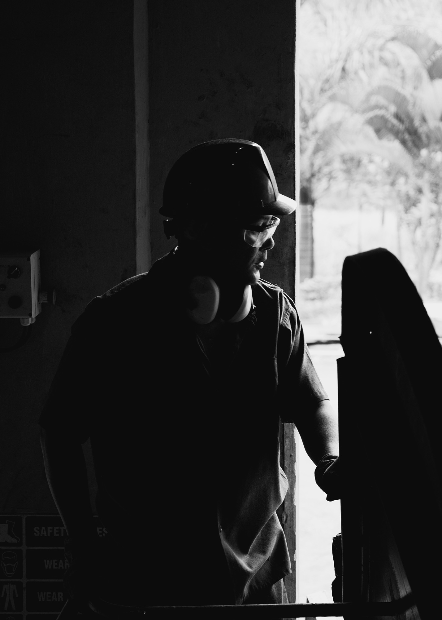 An ASI technician in a hard hat and ear protection